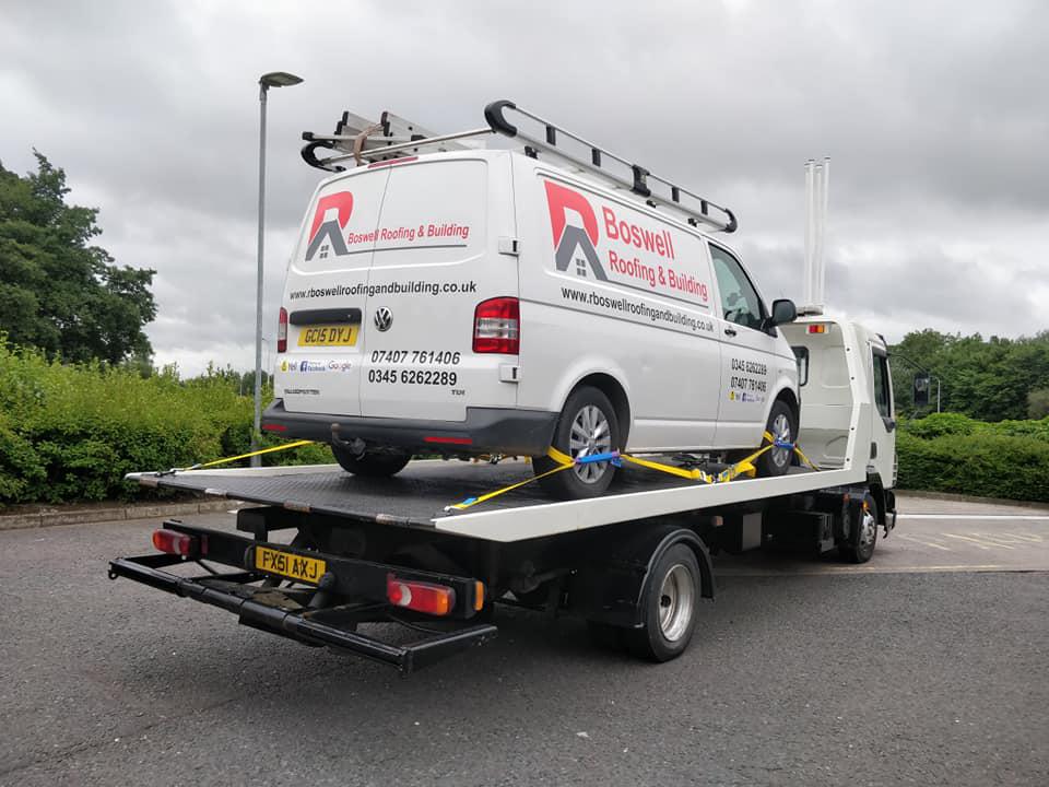 Recovery truck assisting a broken-down vehicle on a major route